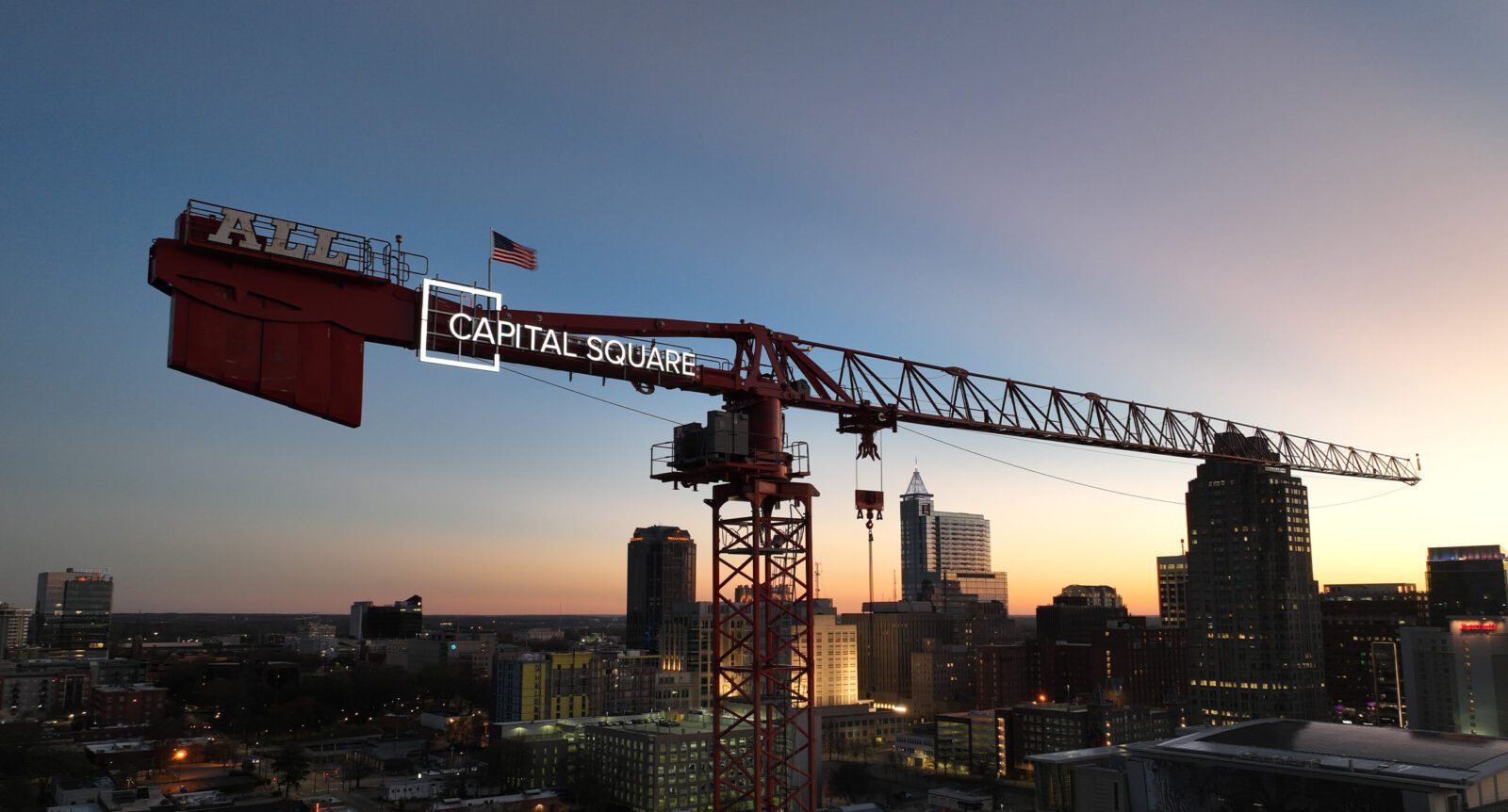 Capital Square construction crane with sunset in background.