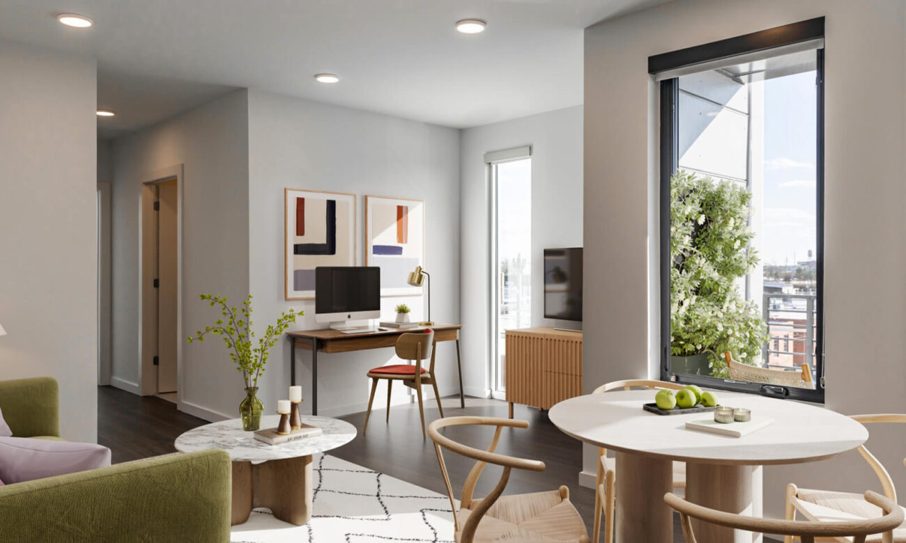 Beautifully decorated living area in apartment with tall windows and lots of natural light.