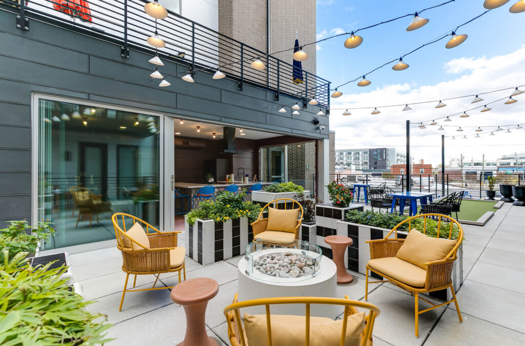 Outdoor patio at the VIV decorated with lights, plants, and colorful furniture