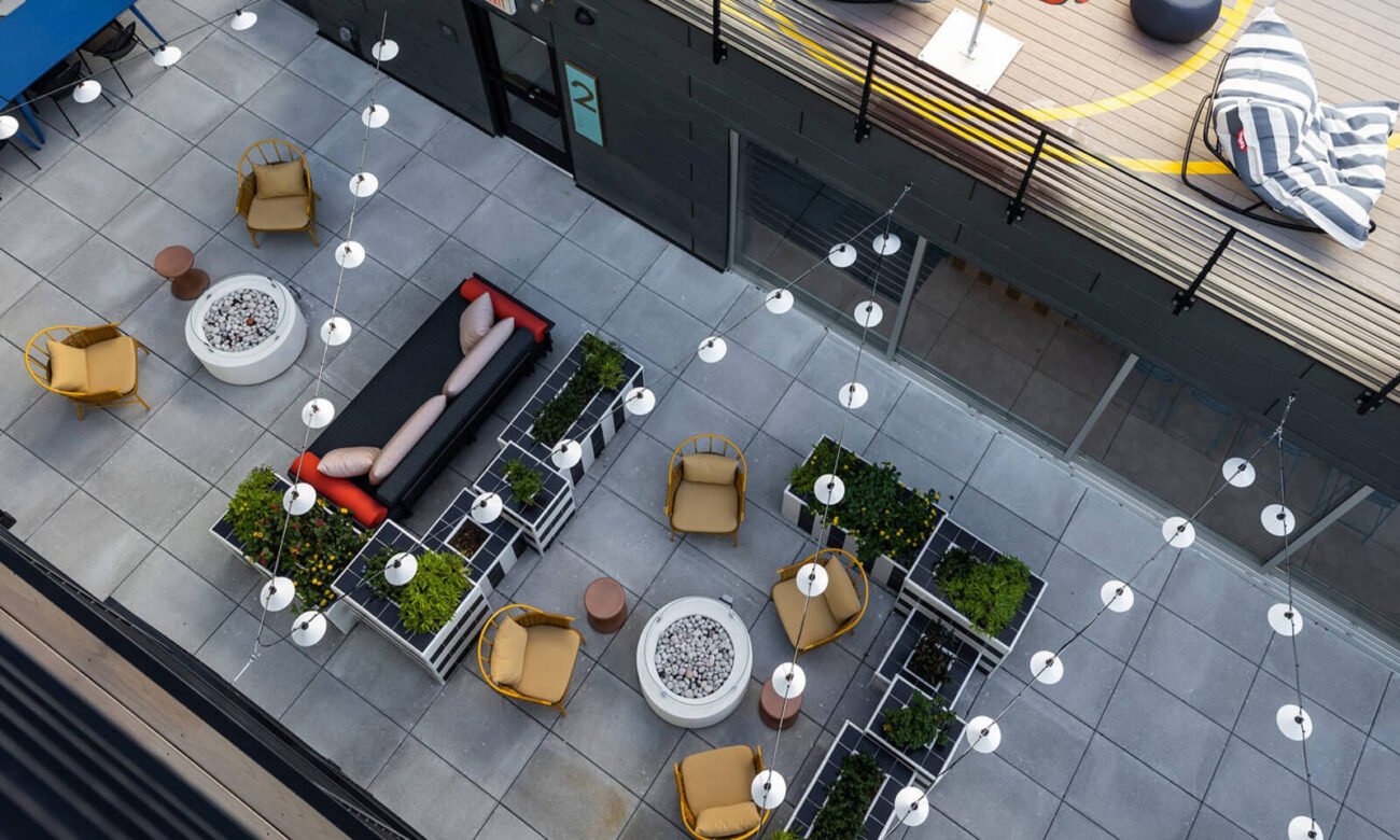 One of the many outdoor seating/hang out areas at VIV with gas fire places and decorative lights hanging above.